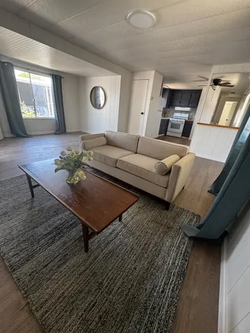 a living room with hard wood floors and a window