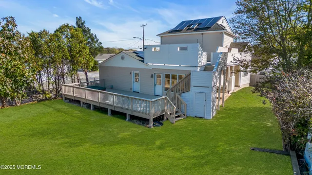 a view of empty room with wooden floor and ceiling fan