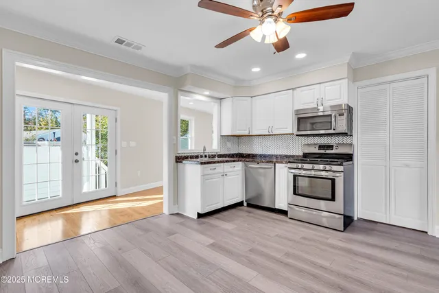 a view of an entryway with wooden floor