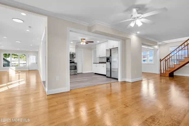 a kitchen with cabinets stainless steel appliances and a window