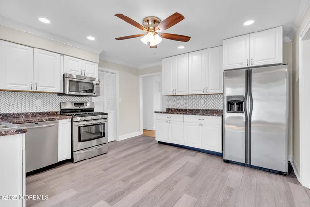a view of a kitchen with a sink and wooden floor