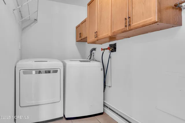 a view of an empty room with wooden floor and window