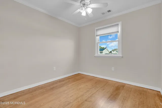 a view of a room with wooden floor and white walls