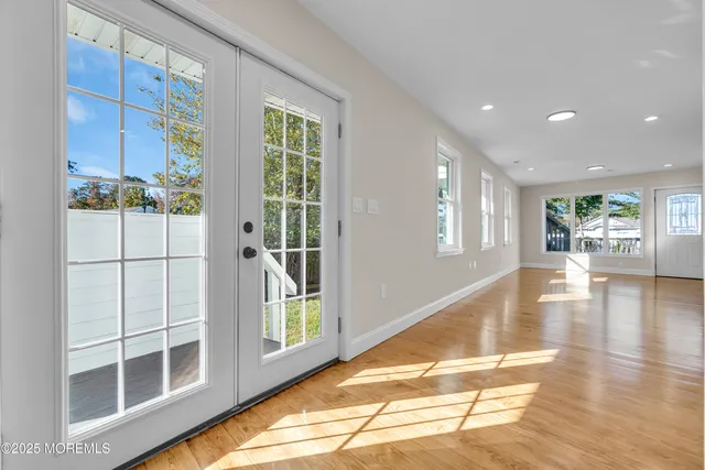 a view of a room with wooden floor and white walls