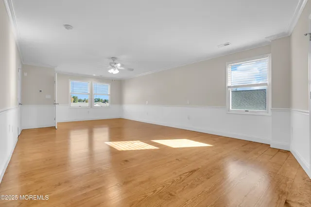 a view of a room with wooden floor