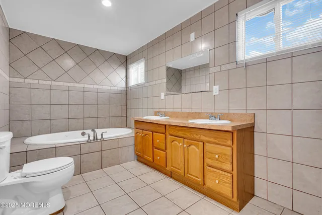 a view of empty room with wooden floor and window
