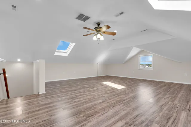 a view of house with deck and trees in the background