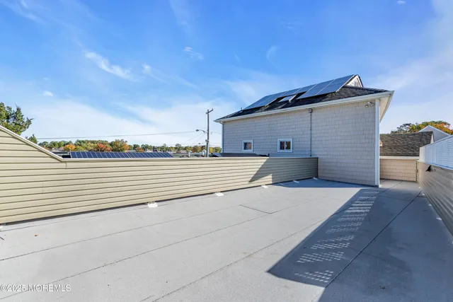 a view of a house next to a big yard and large trees