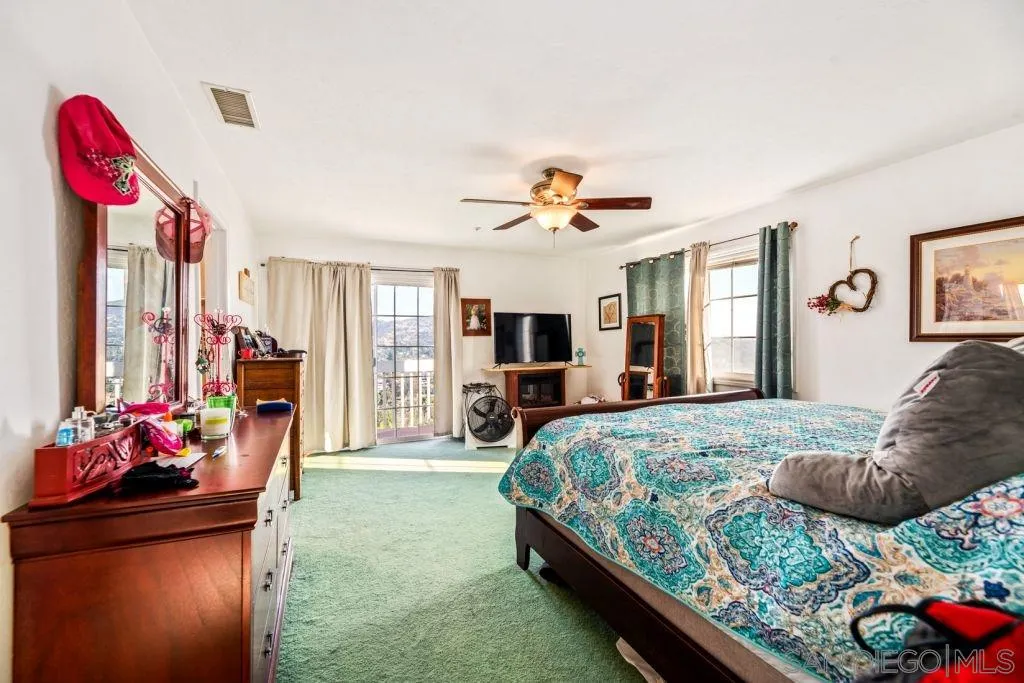 3489 Lakeview Drive Spring Valley, CA 91977 - Photo 15 of 50 a bedroom with a bed and a chandelier