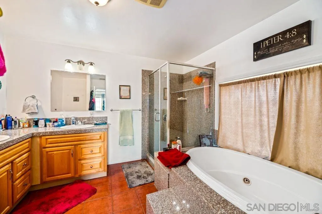 3489 Lakeview Drive Spring Valley, CA 91977 - Photo 18 of 50 a bathroom with a tub a sink and a shower