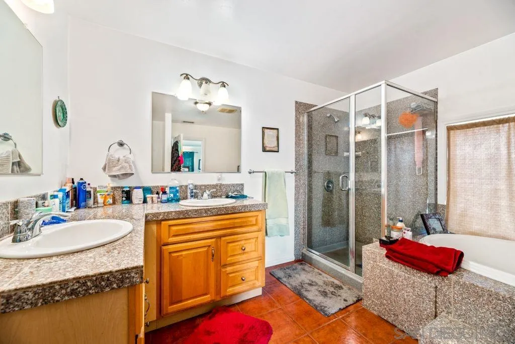 3489 Lakeview Drive Spring Valley, CA 91977 - Photo 19 of 50 a bathroom with a tub sink and mirror