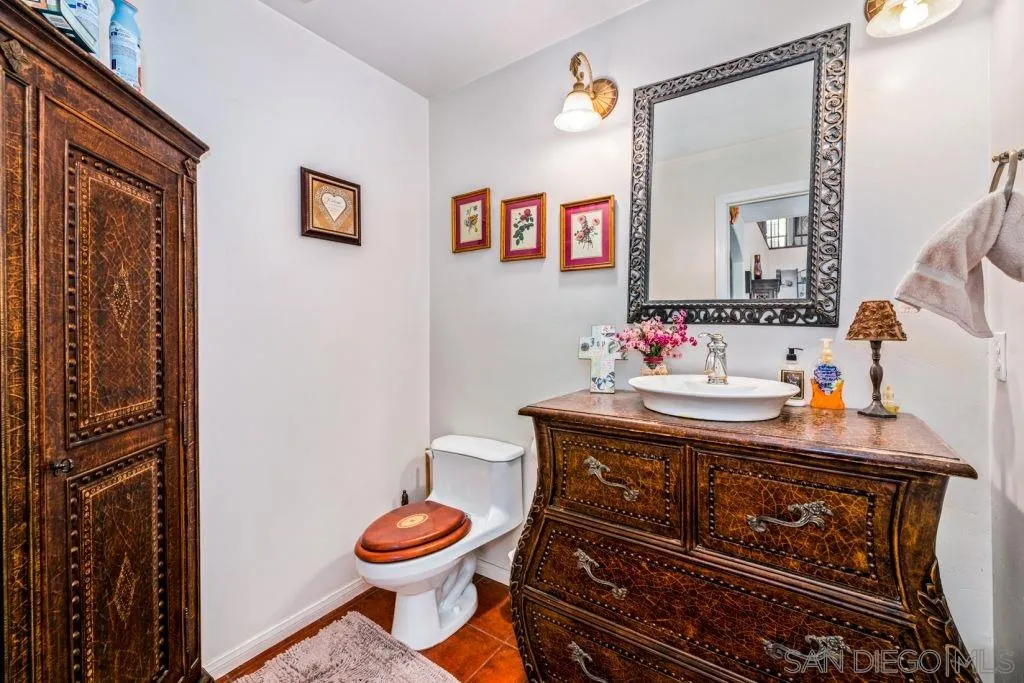 3489 Lakeview Drive Spring Valley, CA 91977 - Photo 20 of 50 a bathroom with a toilet sink and mirror