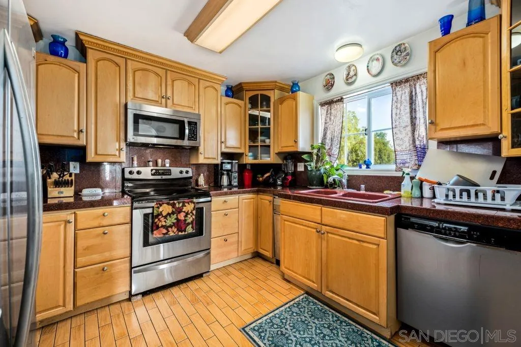 3489 Lakeview Drive Spring Valley, CA 91977 - Photo 29 of 50 a kitchen with stainless steel appliances granite countertop a stove a sink and a microwave