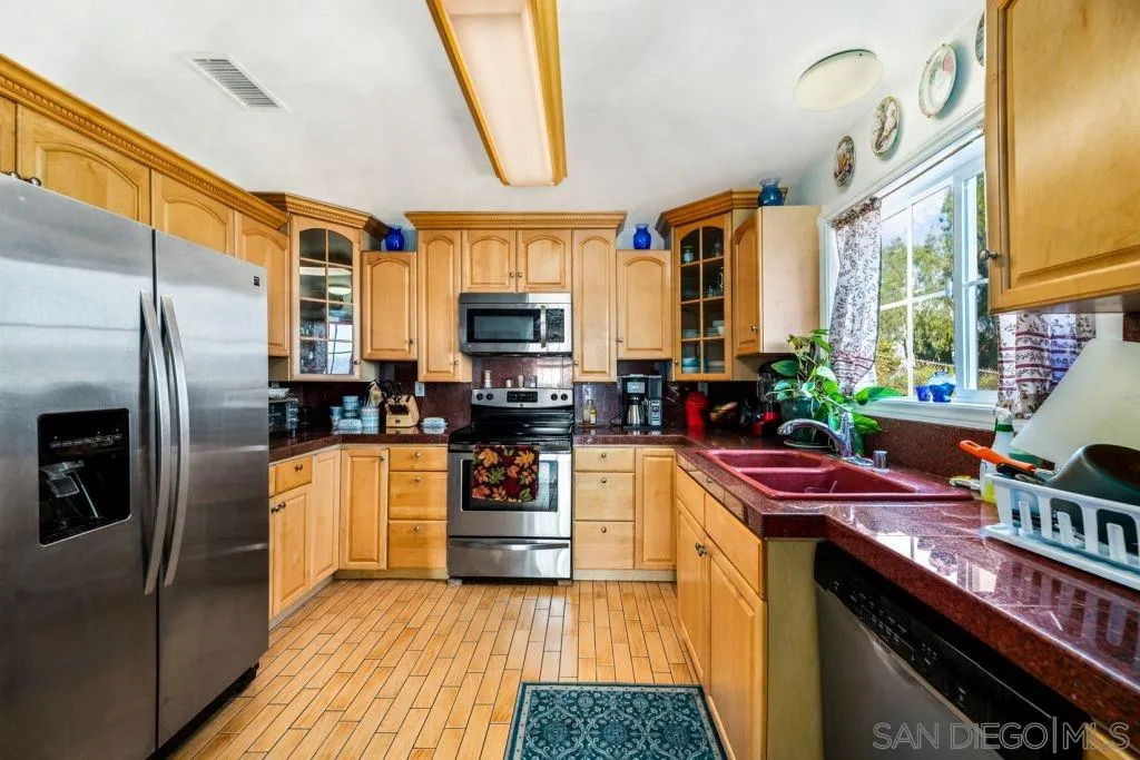 3489 Lakeview Drive Spring Valley, CA 91977 - Photo 30 of 50 a kitchen with stainless steel appliances a sink and a refrigerator