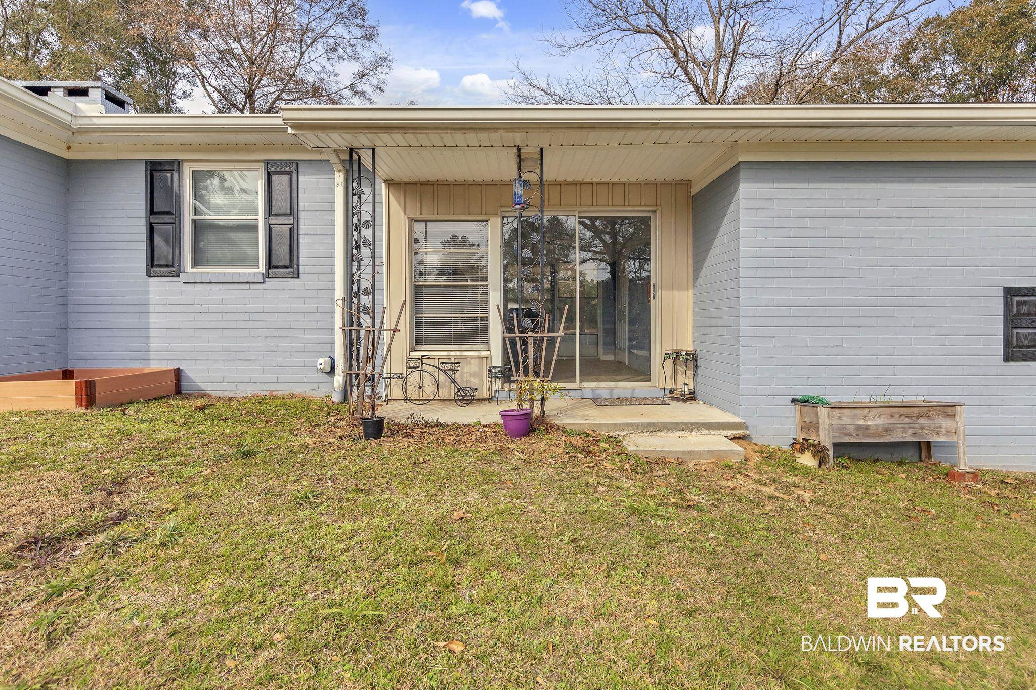 4690 Lott Road Eight Mile, AL 36613 - Photo 11 of 45 Doorway to property featuring a lawn