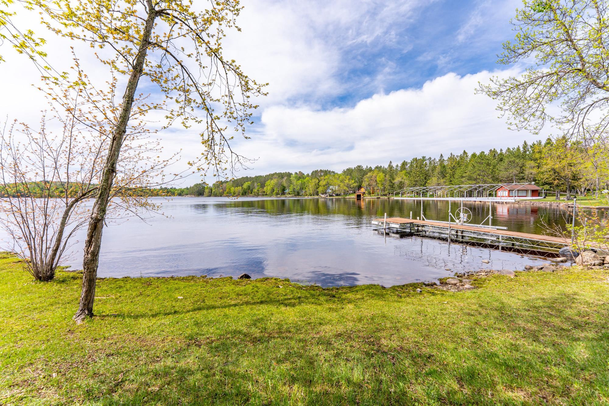 13359 Villa Road Ely, MN 55731 - Photo 5 of 50 Dock featuring a water view, a view of trees, and a lawn
