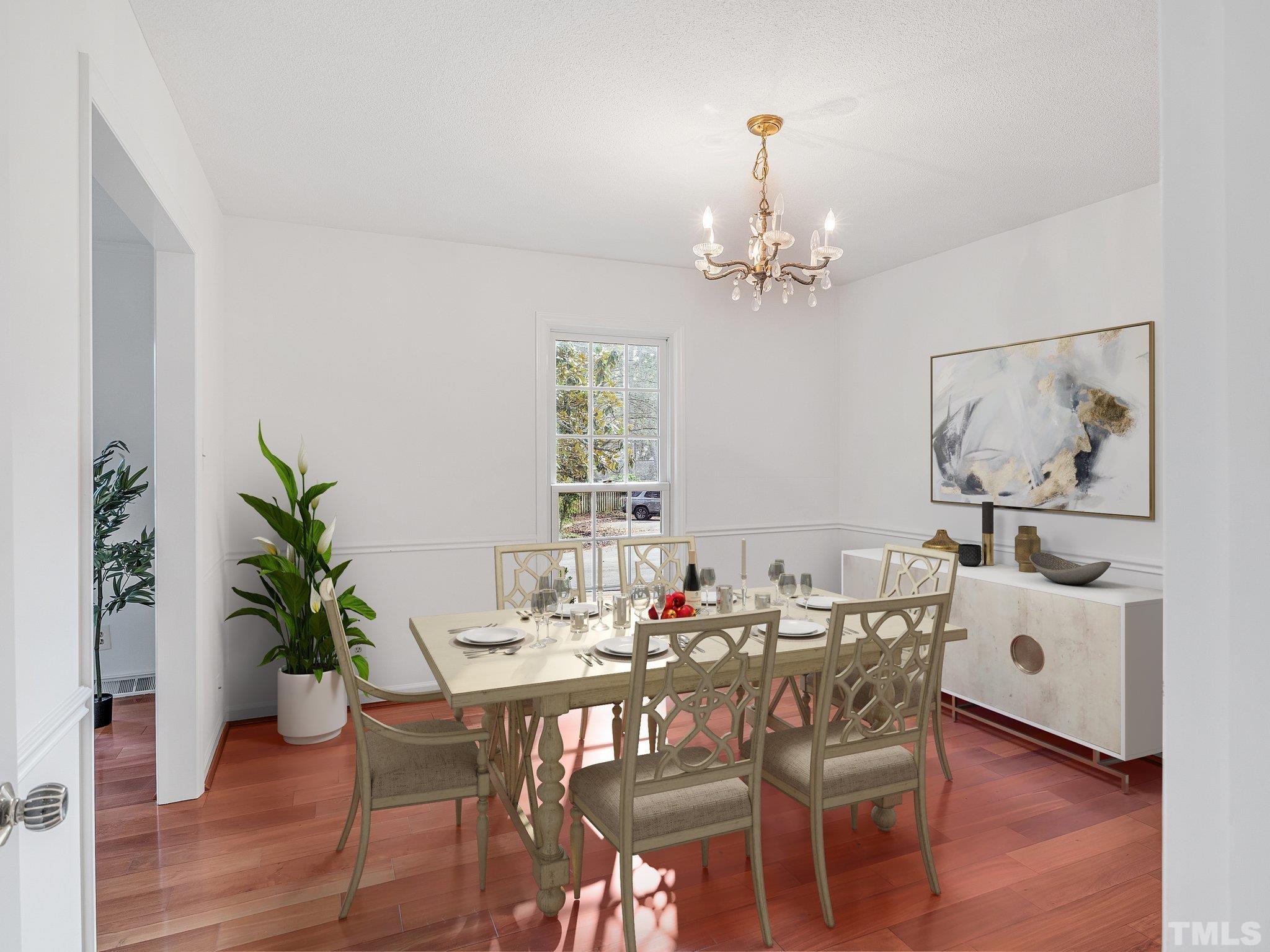 1509 Windbur Place Raleigh, NC 27609 - Photo 16 of 39 a view of a dining room with furniture wooden floor and a chandelier