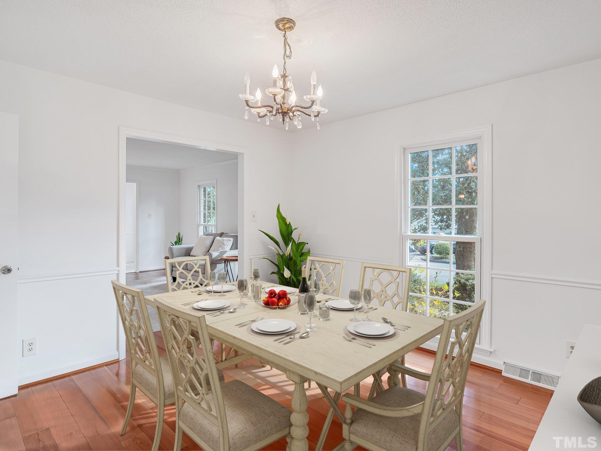 1509 Windbur Place Raleigh, NC 27609 - Photo 17 of 39 a view of a dining room with furniture window and wooden floor