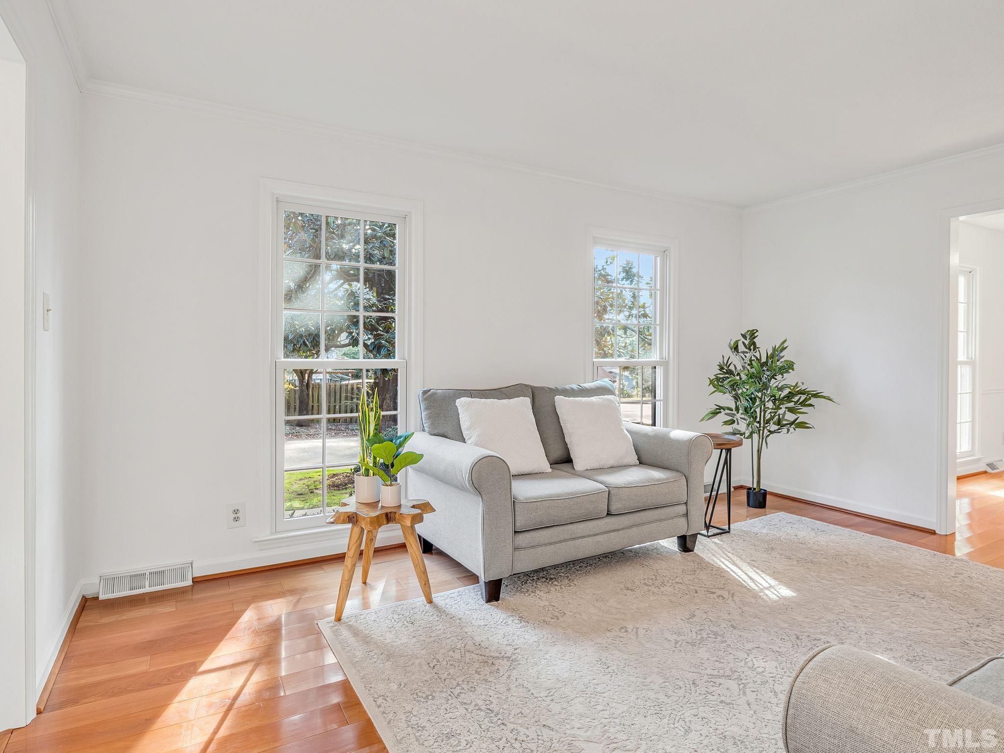 1509 Windbur Place Raleigh, NC 27609 - Photo 20 of 39 a living room with furniture and a potted plant