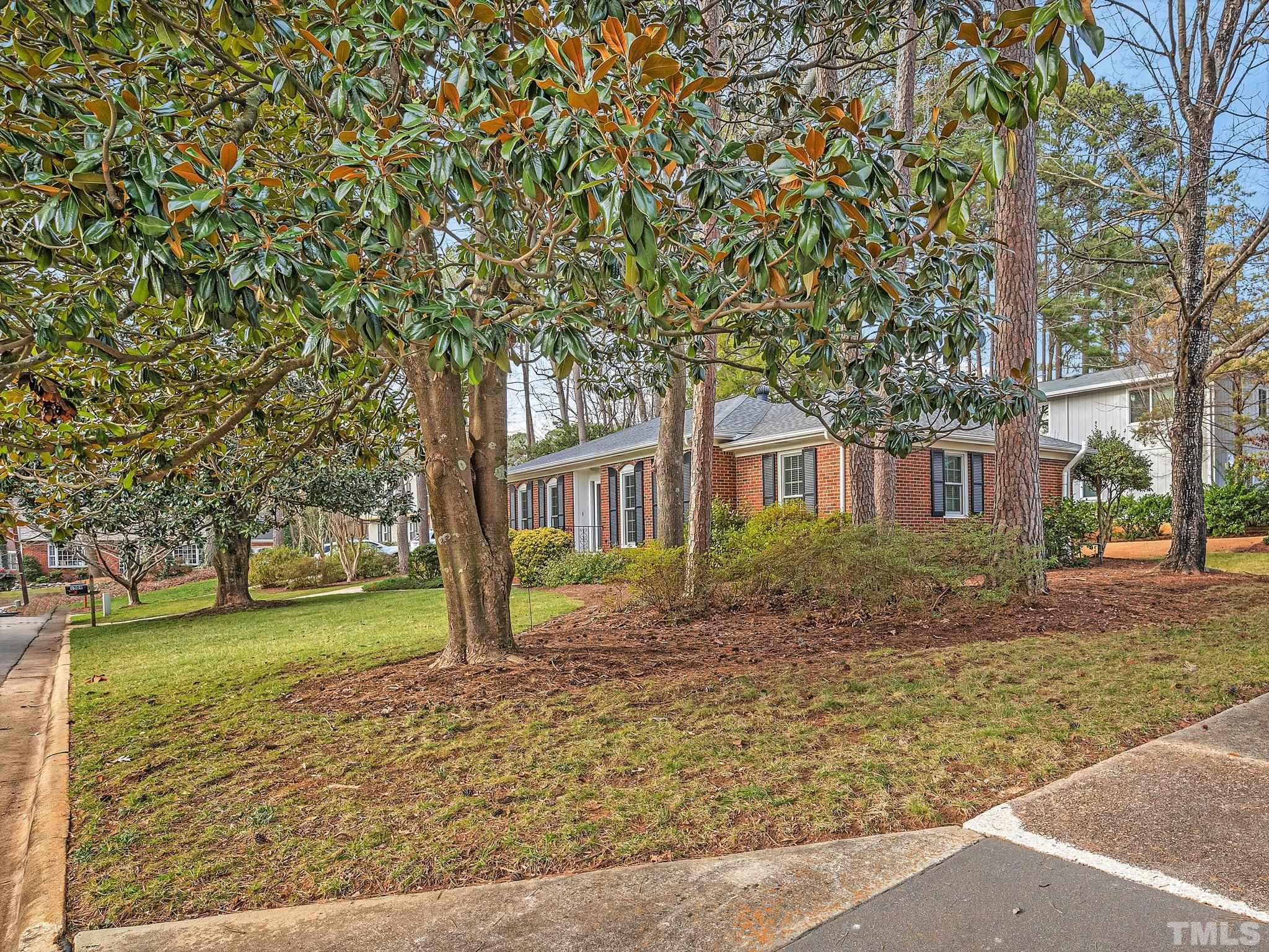 1509 Windbur Place Raleigh, NC 27609 - Photo 2 of 39 a front view of a house with a yard
