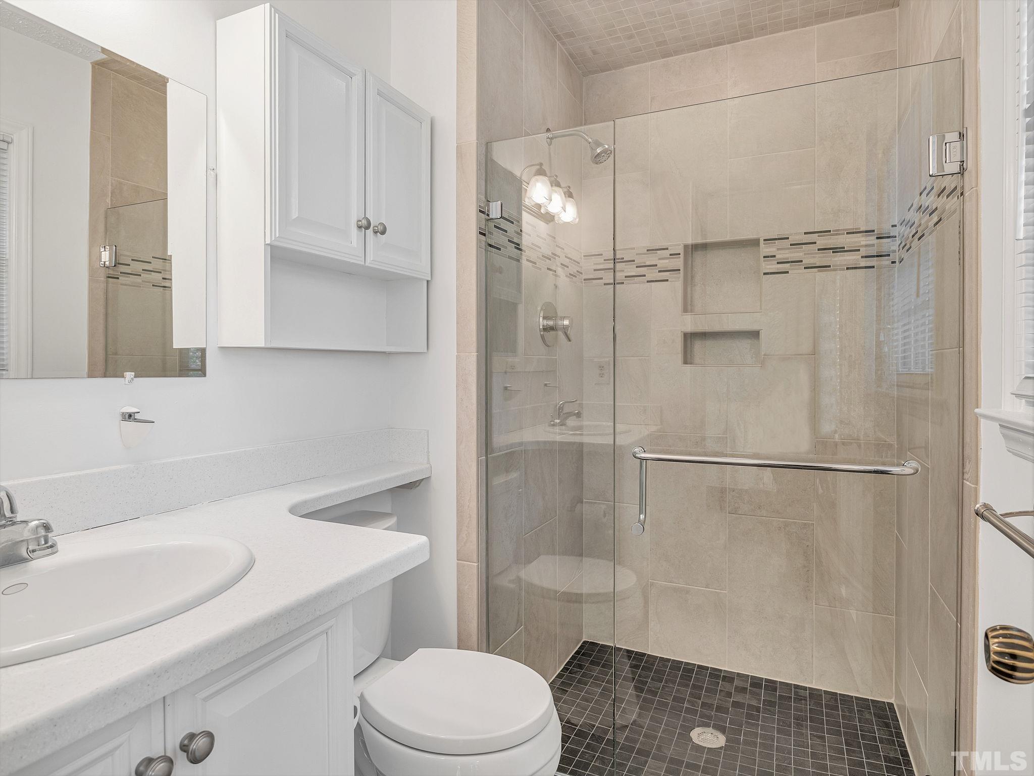 1509 Windbur Place Raleigh, NC 27609 - Photo 25 of 39 a white toilet sitting next to a bathroom sink