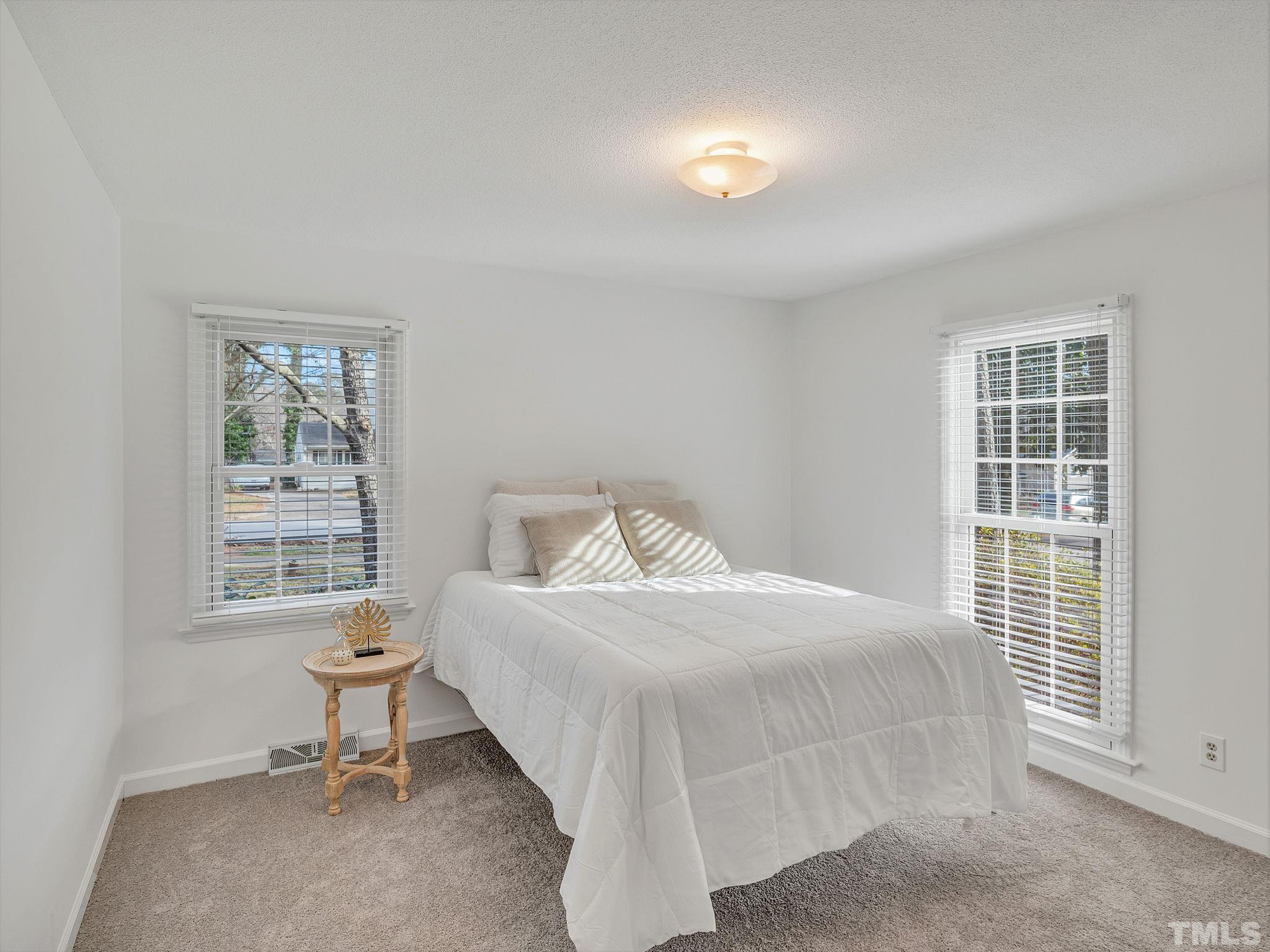 1509 Windbur Place Raleigh, NC 27609 - Photo 27 of 39 a bedroom with a bed and a window