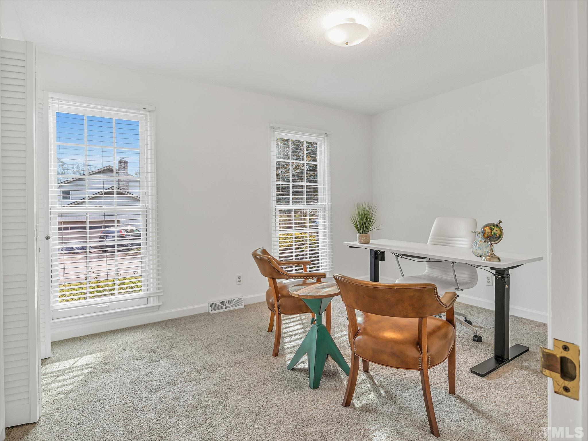 1509 Windbur Place Raleigh, NC 27609 - Photo 29 of 39 a view of a workspace with furniture and a window