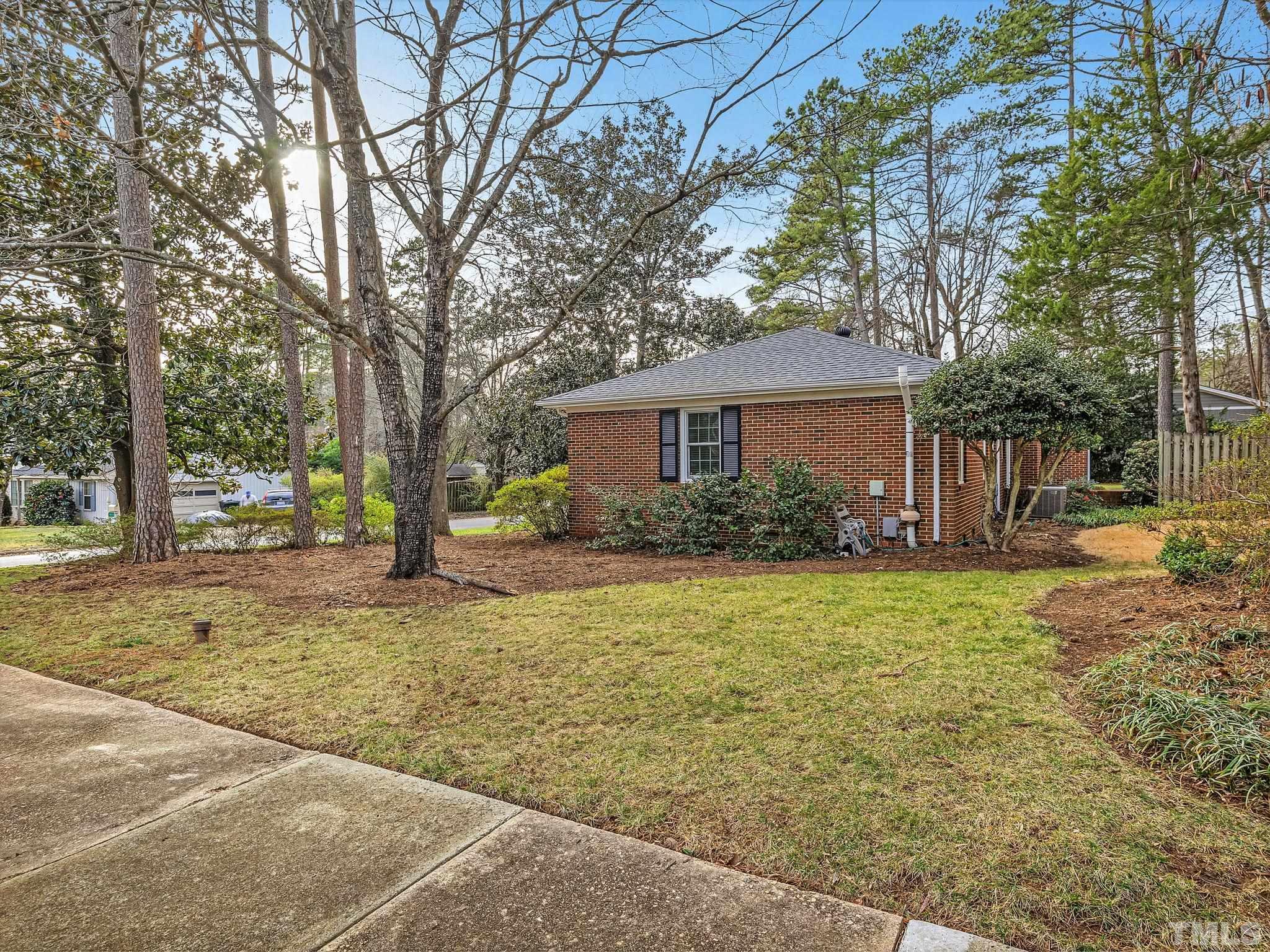 1509 Windbur Place Raleigh, NC 27609 - Photo 34 of 39 a house with trees in front of it