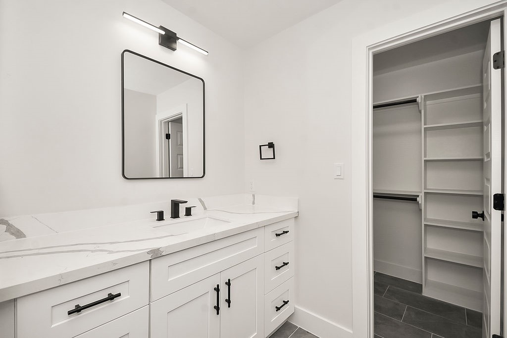 6106 Rutherglenn Drive Houston, TX 77096 - Photo 26 of 41 Modern vanity area with updated fixtures and direct access to spacious storage.