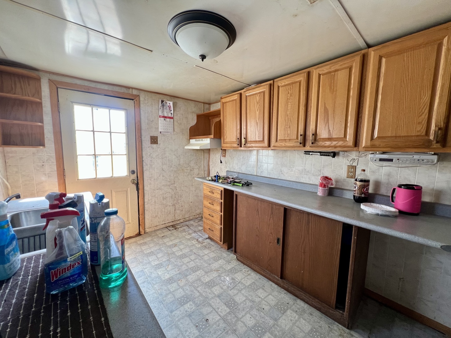 110 South Vermilion Street Potomac, IL 61865 - Photo 12 of 24 a kitchen with granite countertop lots of clutter and stainless steel appliances