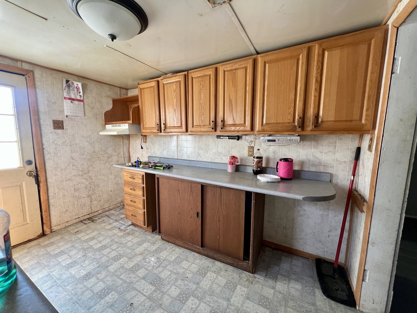 110 South Vermilion Street Potomac, IL 61865 - Photo 13 of 24 a kitchen with granite countertop a sink refrigerator and cabinets