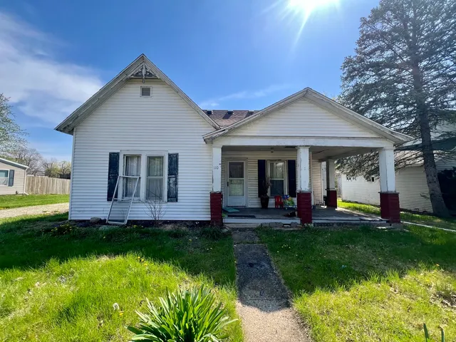 a front view of a house with a yard and porch