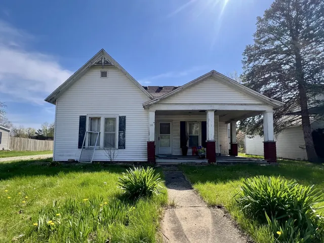 a front view of a house with a yard table and chairs