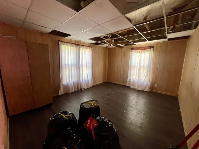 a view of a room with wooden floor and windows