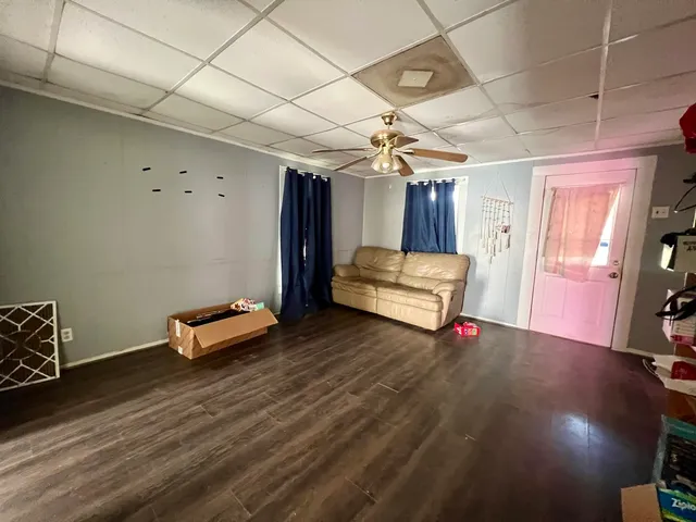 a view of a room with wooden floor and furniture