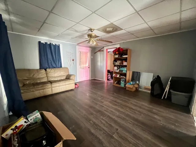a view of a room with wooden floor and windows