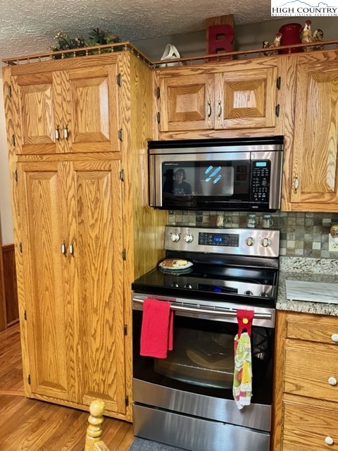 191 Welch Road Lansing, NC 28643 - Photo 14 of 41 a kitchen with stainless steel appliances granite countertop a stove and a microwave