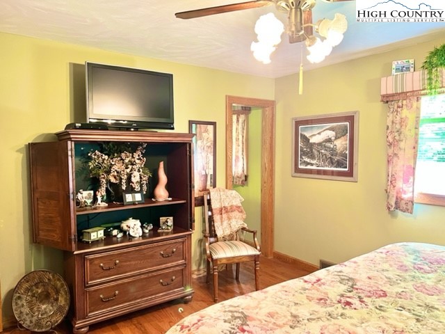 191 Welch Road Lansing, NC 28643 - Photo 17 of 41 a bedroom with a bed and a flat screen tv
