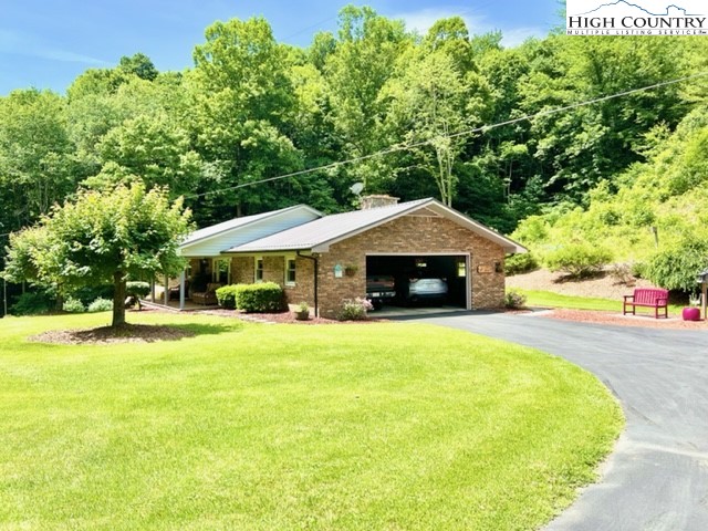 191 Welch Road Lansing, NC 28643 - Photo 29 of 41 a front view of a house with a yard