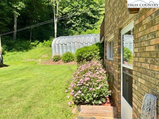 191 Welch Road Lansing, NC 28643 - Photo 36 of 41 a garden view with a plant in front of it