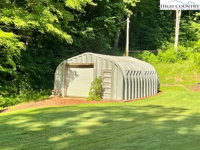 191 Welch Road Lansing, NC 28643 - Photo 4 of 41 a front view of a house with garden