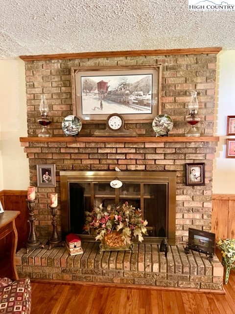 191 Welch Road Lansing, NC 28643 - Photo 8 of 41 a living room with fireplace furniture and a large window