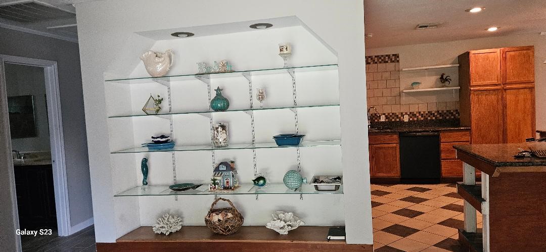 4102 California Avenue Dickinson, TX 77539 - Photo 2 of 19 a kitchen with a refrigerator and cabinets