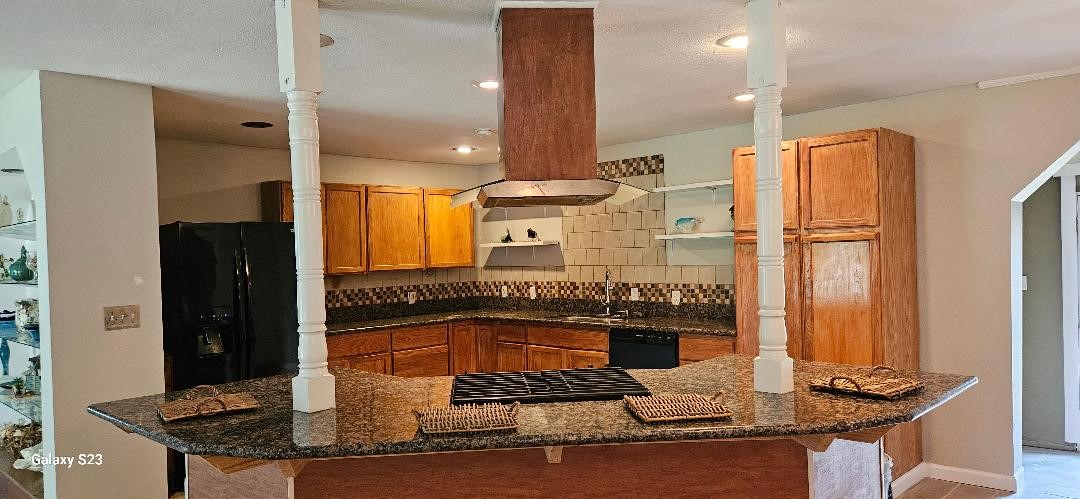 4102 California Avenue Dickinson, TX 77539 - Photo 6 of 19 a kitchen with kitchen island a counter top space and a refrigerator