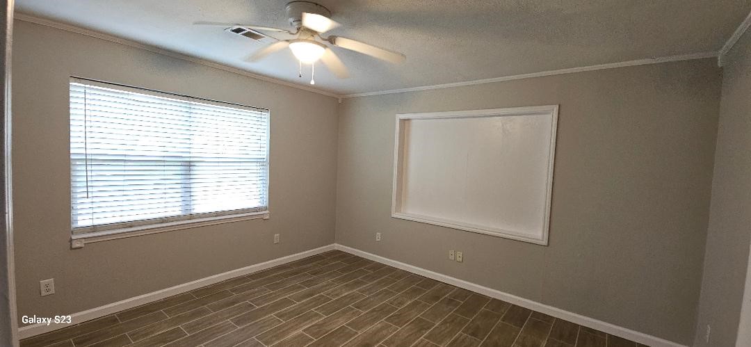 4102 California Avenue Dickinson, TX 77539 - Photo 9 of 19 an empty room with a window and a fan