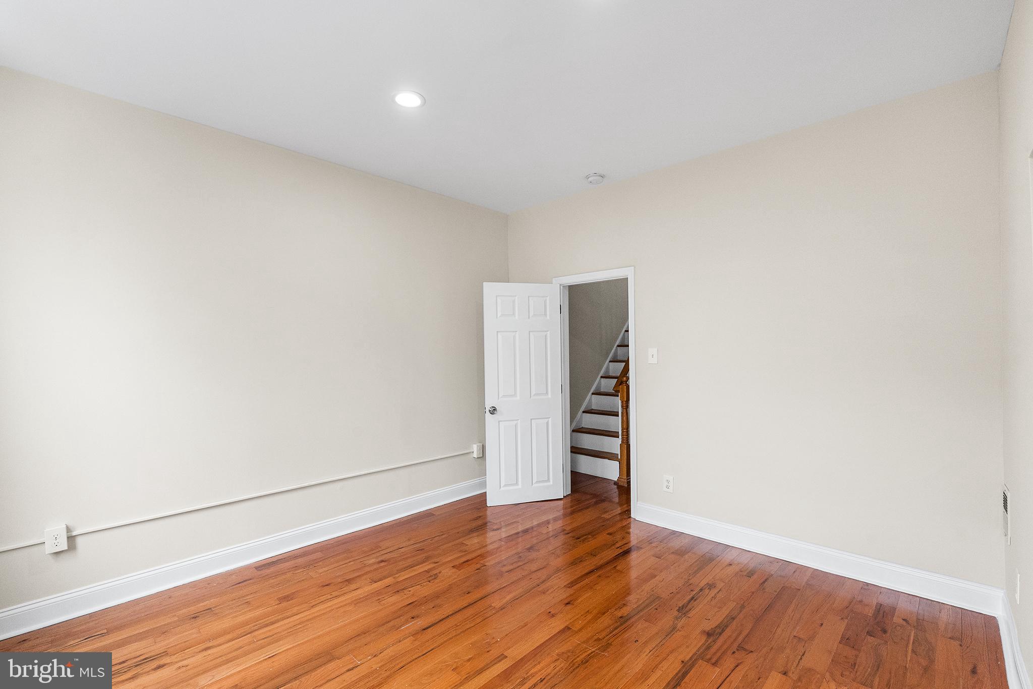 1538 Tasker Street Philadelphia, PA 19145 - Photo 16 of 23 an empty room with wooden floor