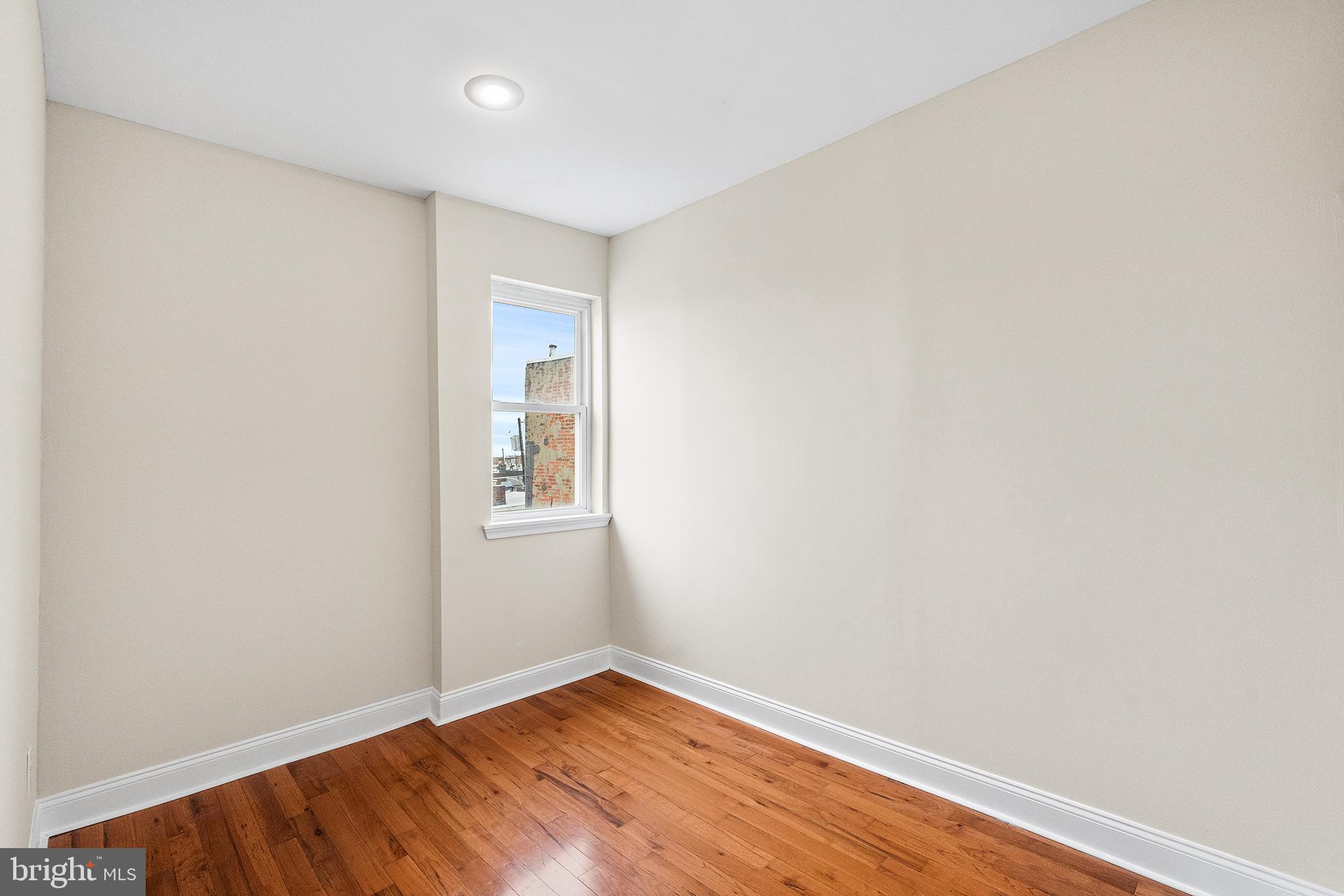 1538 Tasker Street Philadelphia, PA 19145 - Photo 17 of 23 a view of an empty room with wooden floor