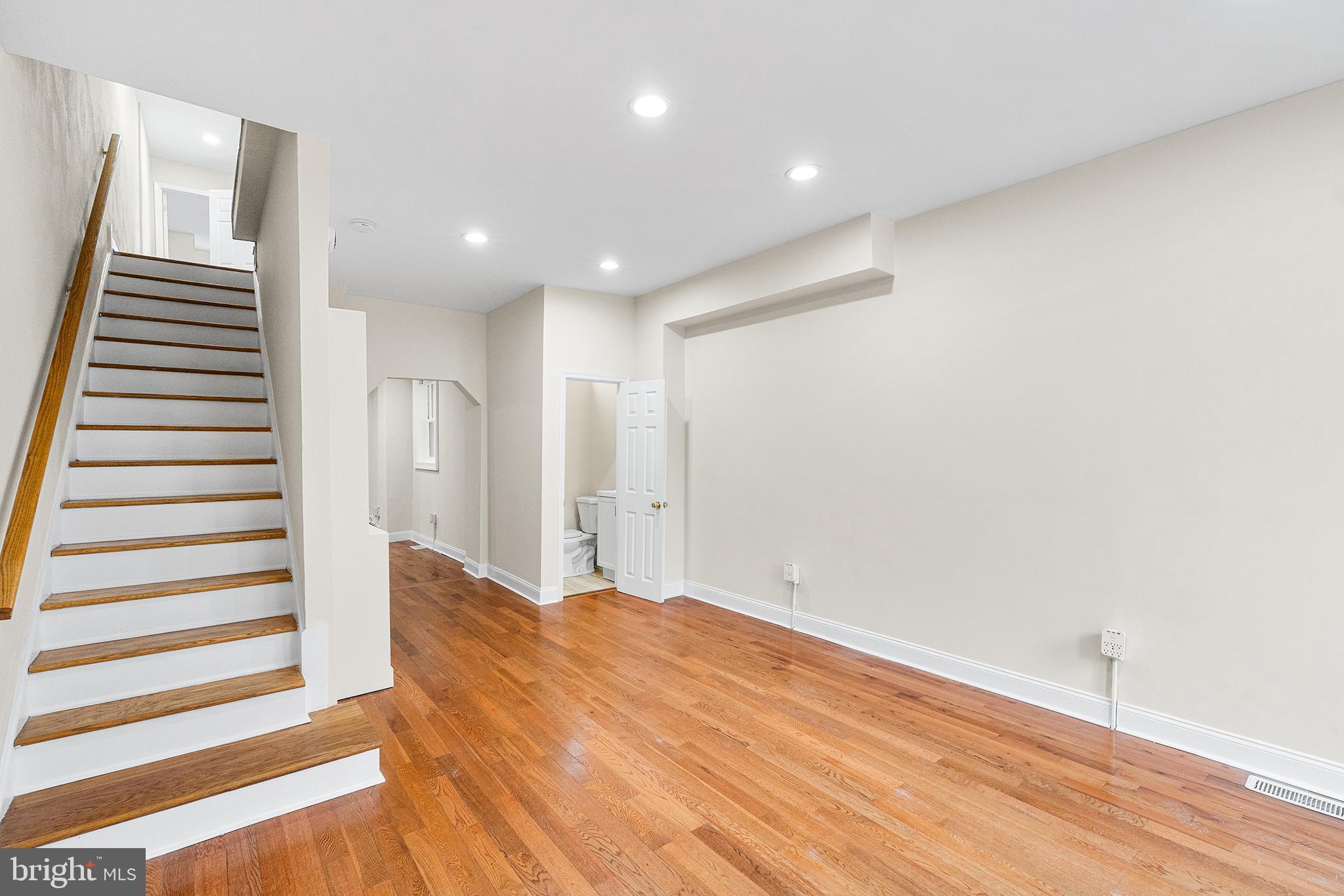1538 Tasker Street Philadelphia, PA 19145 - Photo 4 of 23 a view of a room with stairs and wooden floor