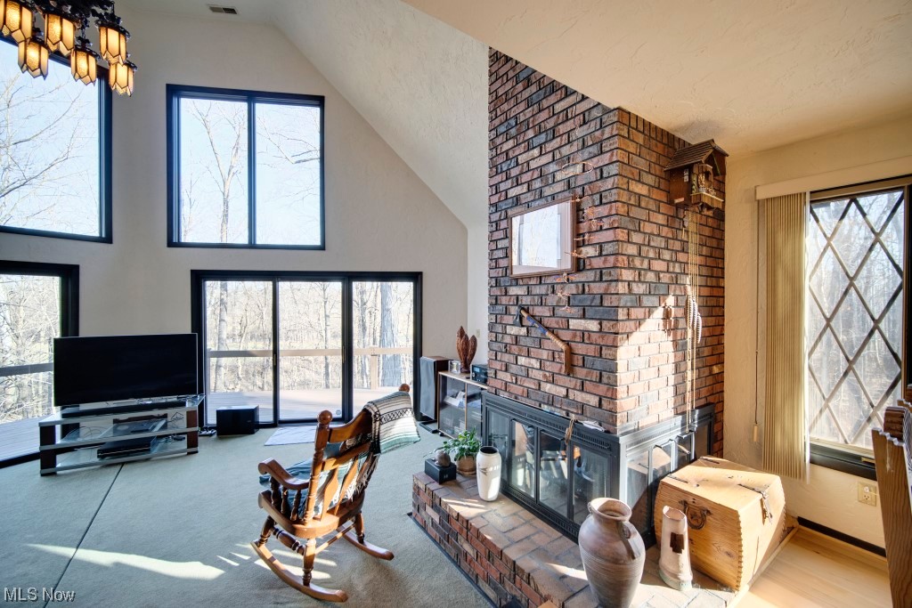 41974 Butternut Ridge Road Elyria, OH 44035 - Photo 21 of 50 Carpeted living room with a brick fireplace and a healthy amount of sunlight