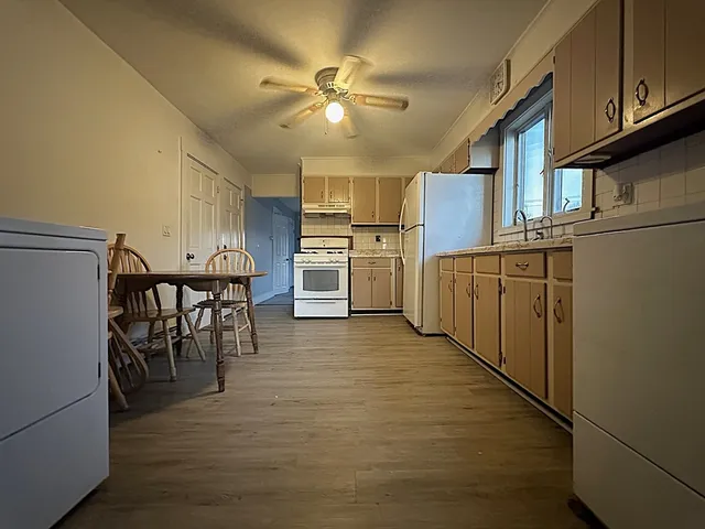 a kitchen with refrigerator and cabinets